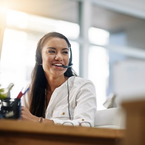 Woman wearing a telephone headset and smiling